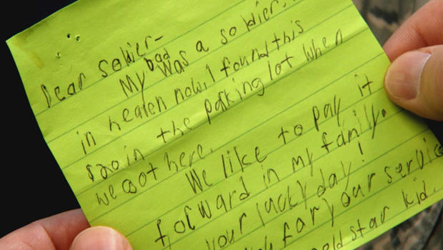 boy gives note to soldier