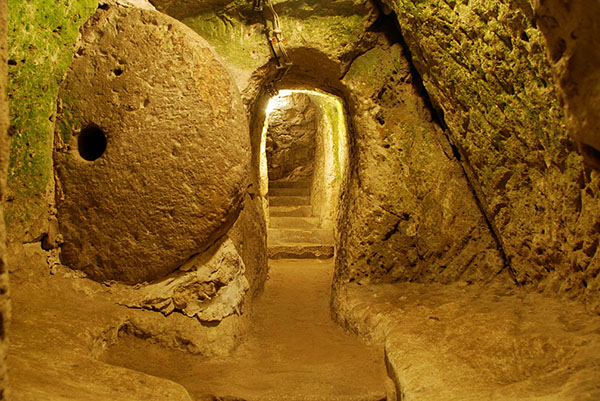 Hallway and stone door in underground tunnel in Turkey. www.salemtunneltour.com