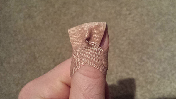 how to bandage a finger so it stays on