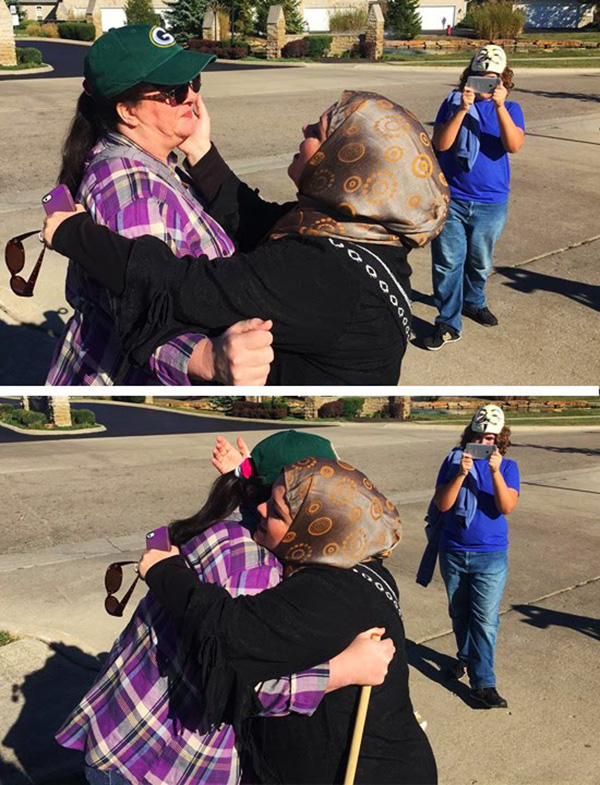 muslim woman hugs protestor