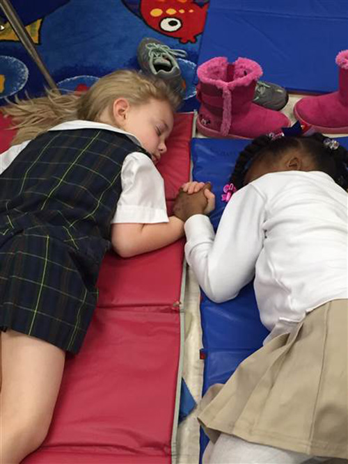 black and white students holding hands sleeping