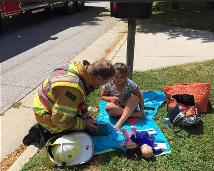 firefighter distracts girl from fire happy news
