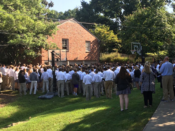 400 students sing outside teachers house