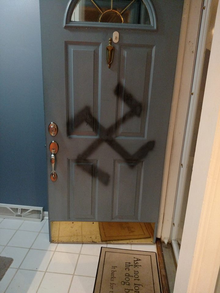 woman battles hate with love swastika on door quotes