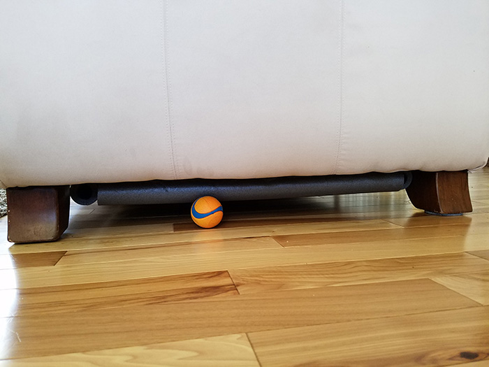 pipe insulation under couch for dog toys