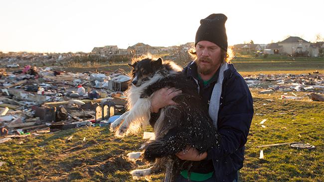 man finds dog in rubble