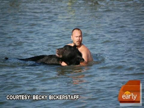 man saves bear from drowning