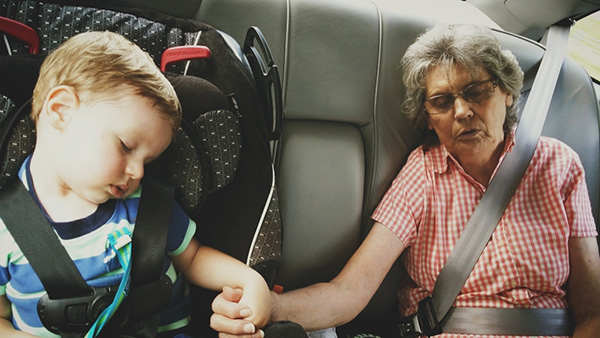 grandma and grandson fall asleep holding hands