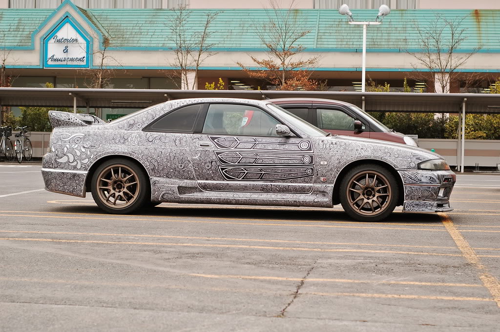 woman draws designs on car with sharpie