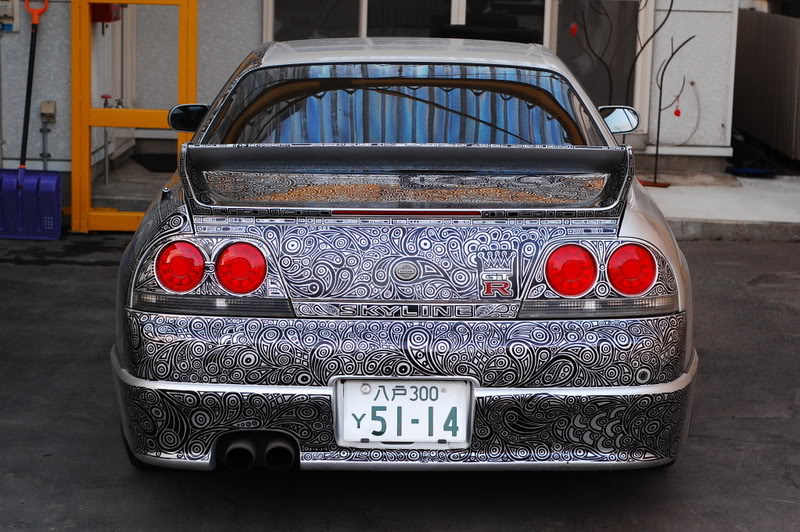 woman draws designs on car with sharpie