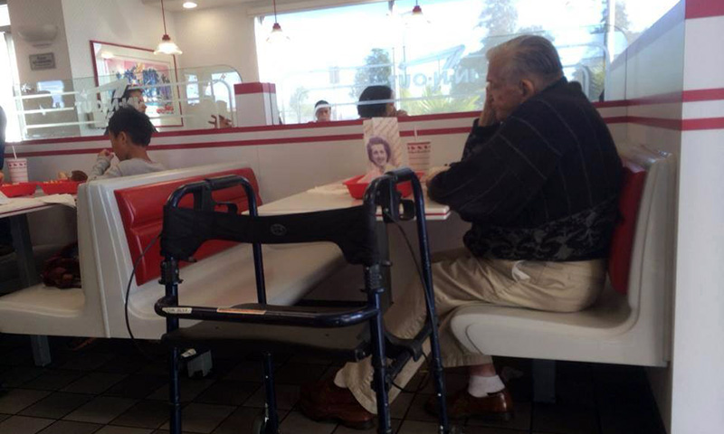 old man eats alone with wifes picture