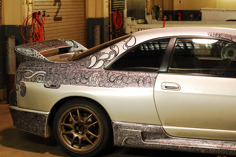 woman draws designs on car with sharpie