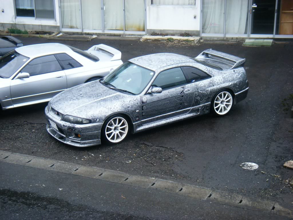 woman draws designs on car with sharpie