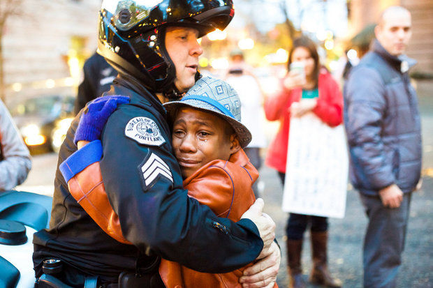 cop hugs Ferguson protestor