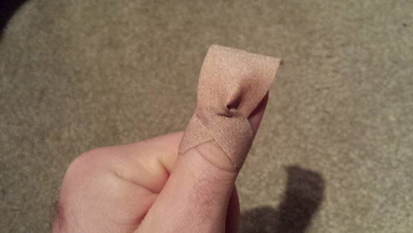 how to bandage a finger so it stays on