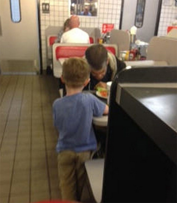 boy feeds homeless man waffle house