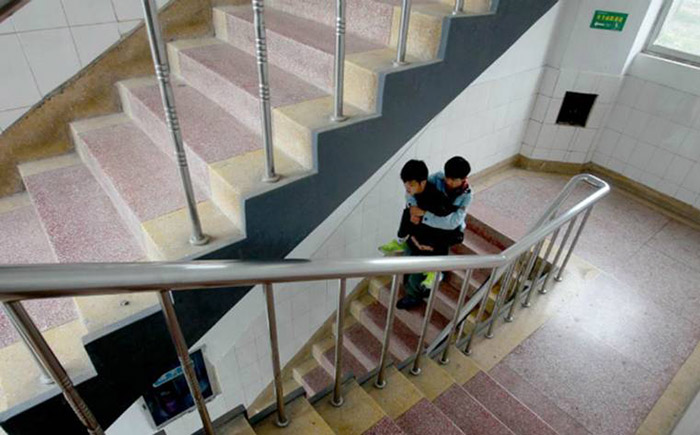 boy carries his friend to class 3 years