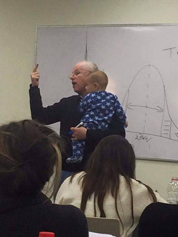 professor holds baby during lecture