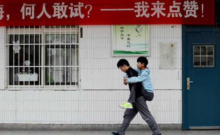 boy carries his friend to class 3 years