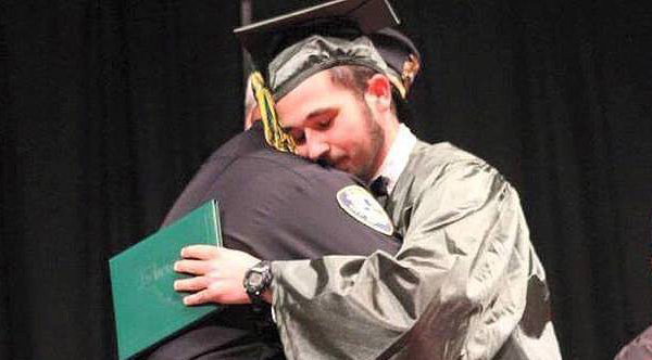 cop hug at graduation of boy who lost his parents