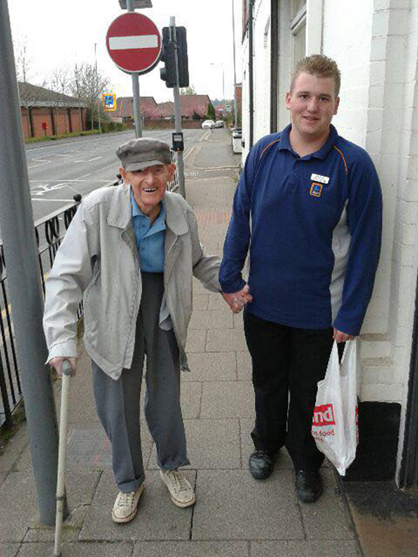 young supermarket employee walks elderly man home