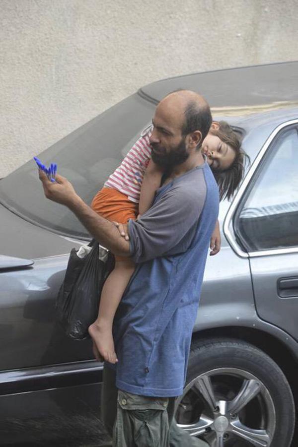 Syrian man selling pens