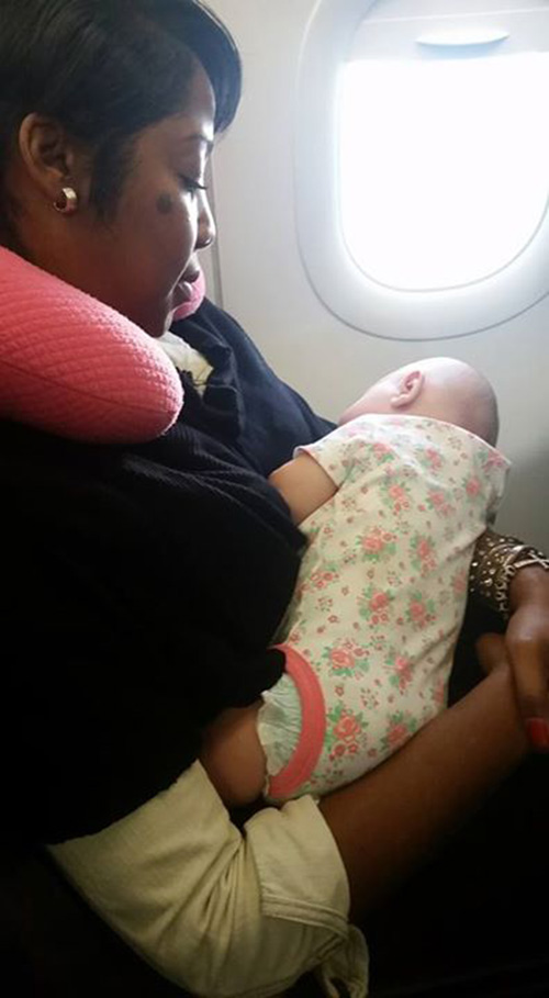 stranger holds crying baby on plane