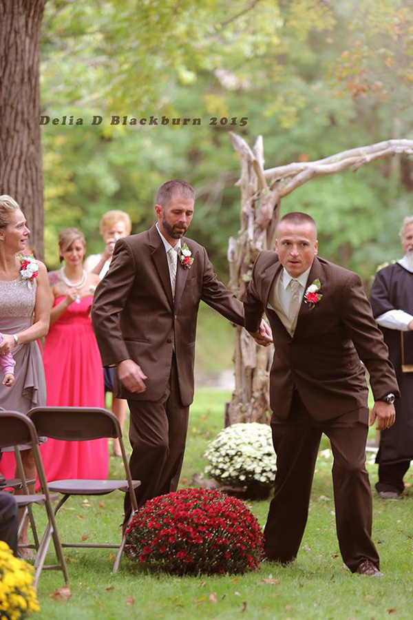 father of bride grabs father in law to walk her down aisle together