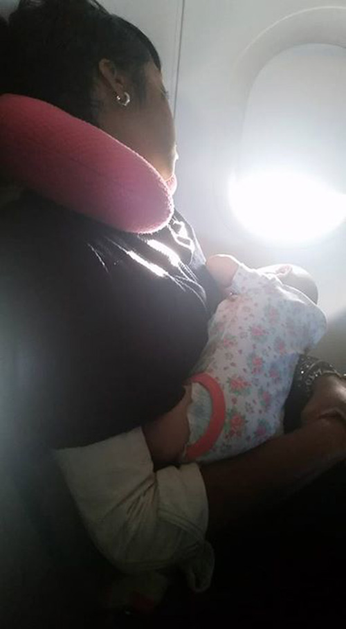 stranger holds crying baby on plane