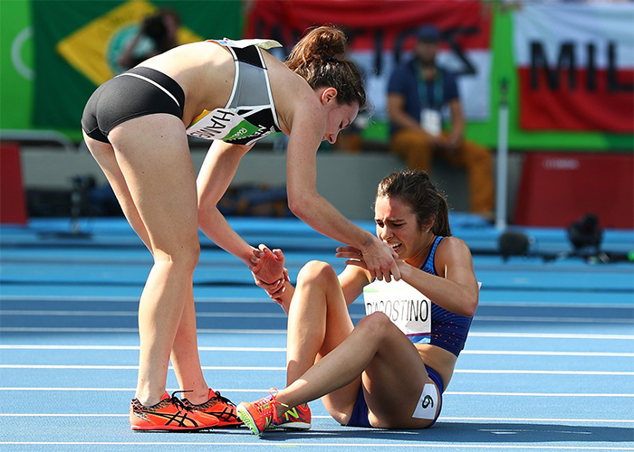 runner helps runner get up olympics