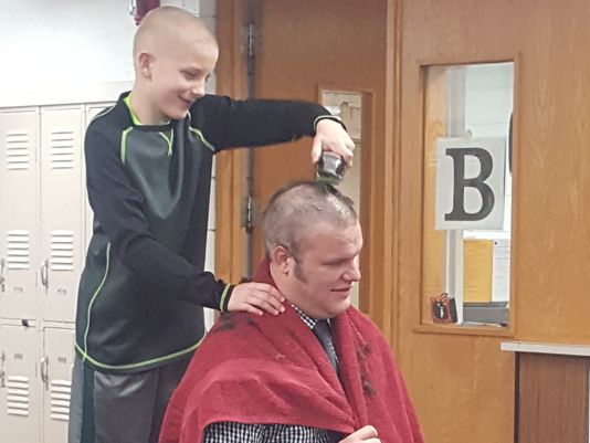 principal shaves head for bald student