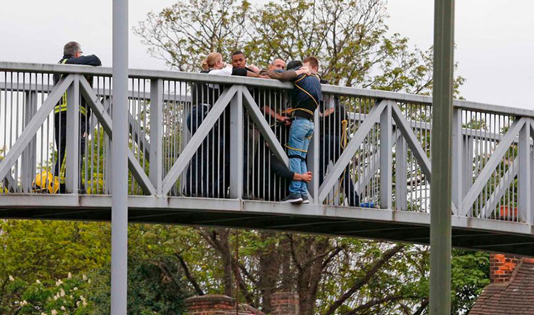 crowd hangs on to suicidal man