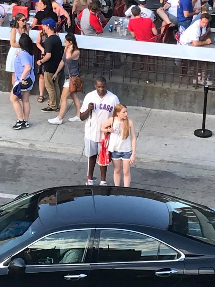 woman helps blind man hail a cab