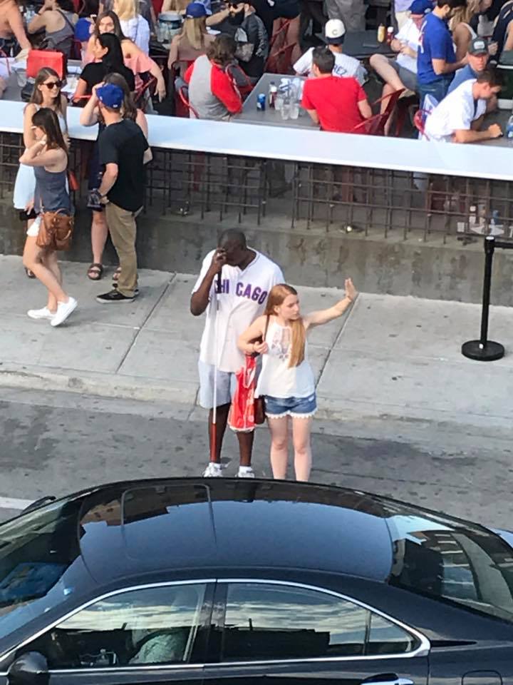 woman helps blind man hail a cab