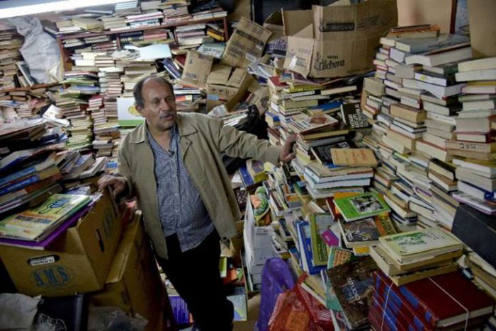 garbage man opens library with books in trash