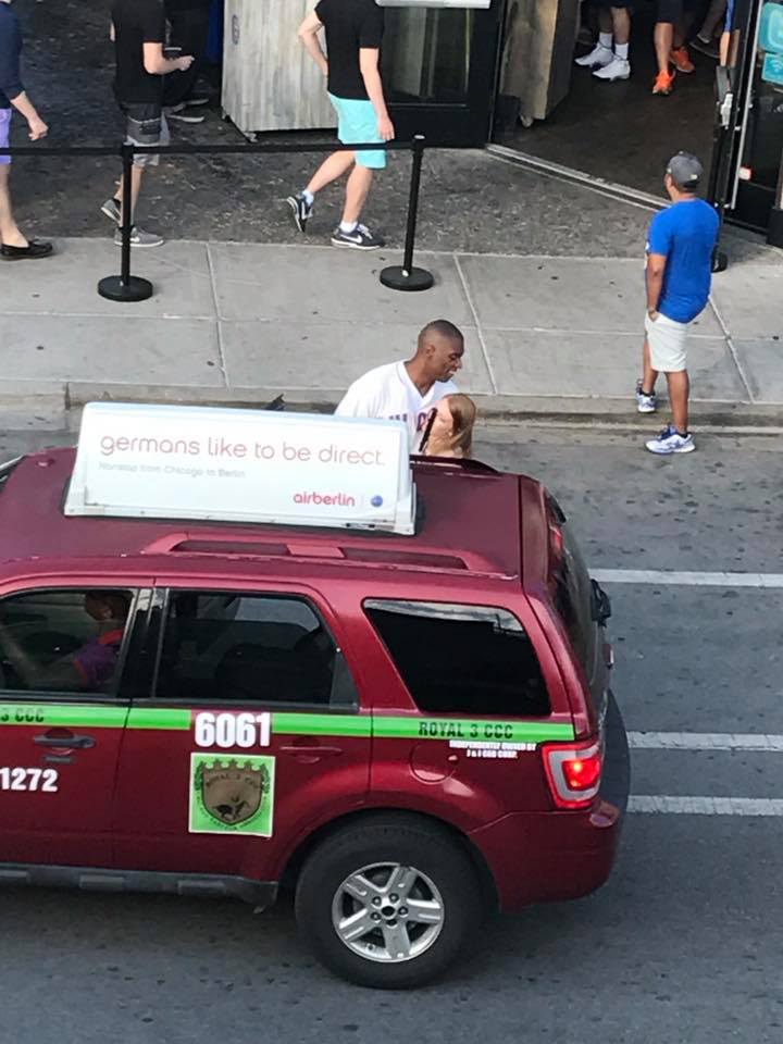 woman helps blind man hail a cab