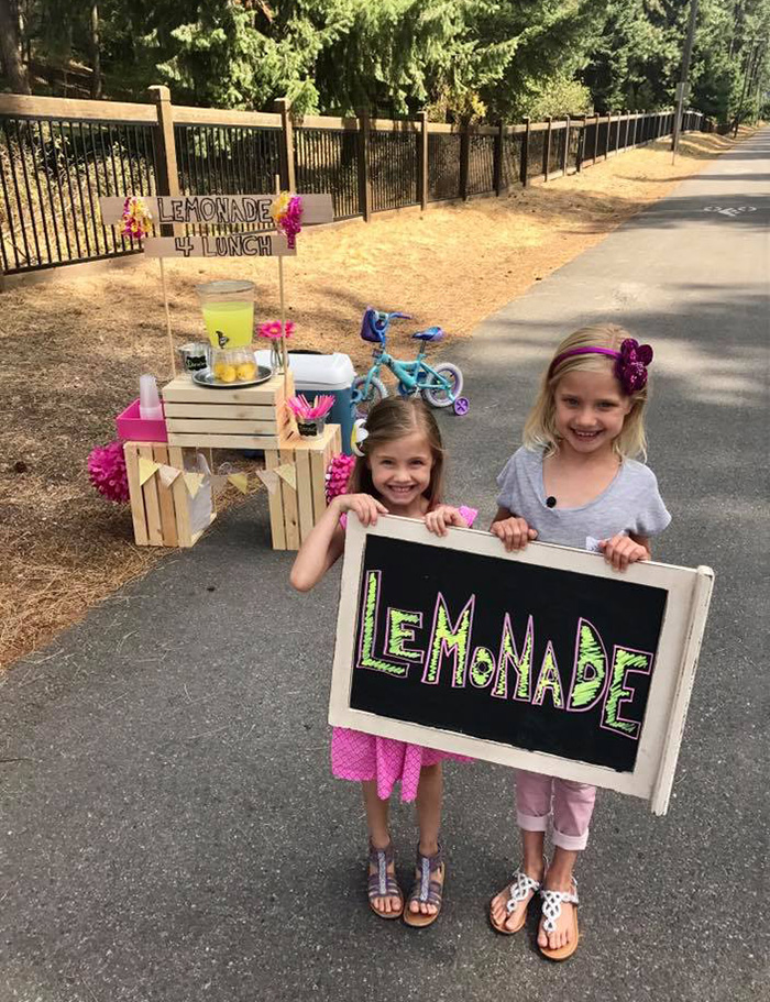 little girl lemonade stand pay student lunch debt