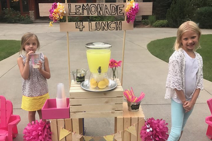 little girl lemonade stand pay student lunch debt