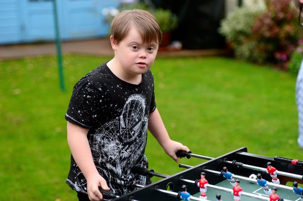 boy down syndrome model clothing store