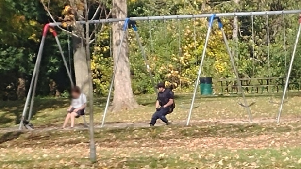 cop helps distressed man talks to him on swings