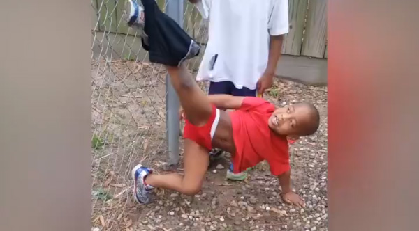 This little kid rips his pants trying to climb over fence, then he rips his...
