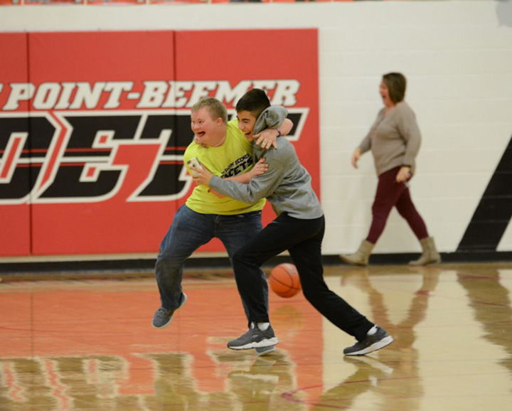 student with down syndrome hits backwards half court shot