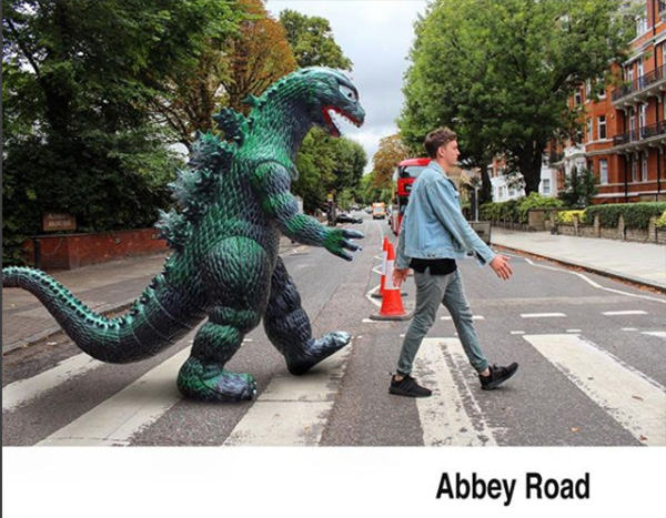 man travels with godzilla toy photoshop