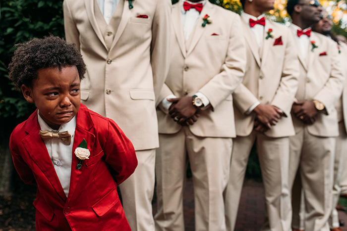 boy in tears at parents wedding