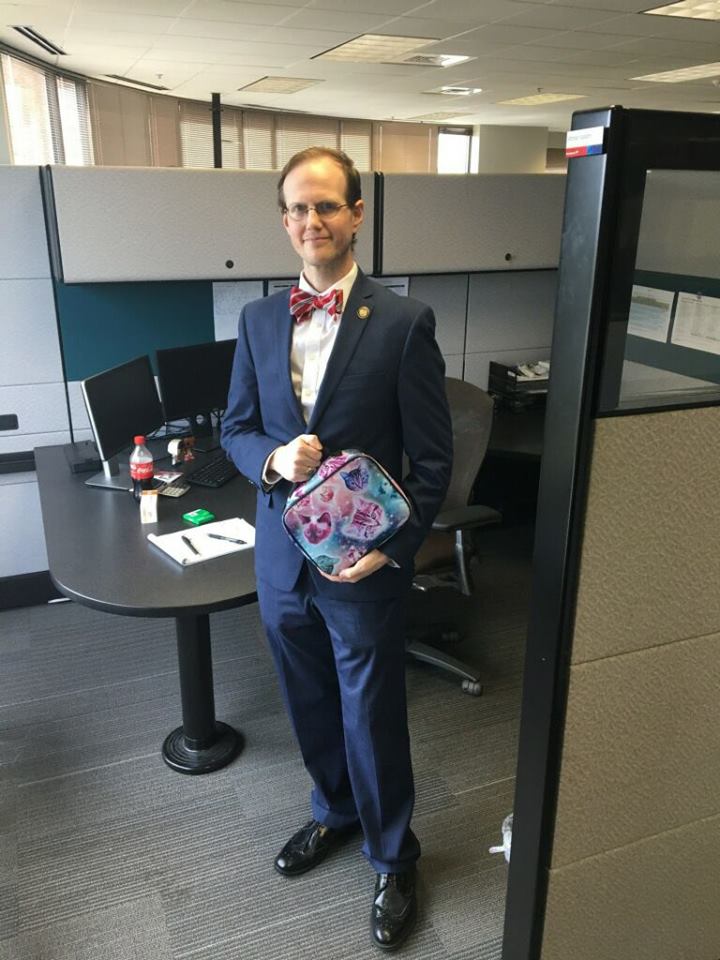 man takes cat lunch box to work