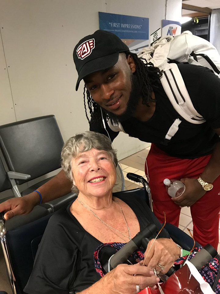 nfl player pushes woman in wheelchair at airport