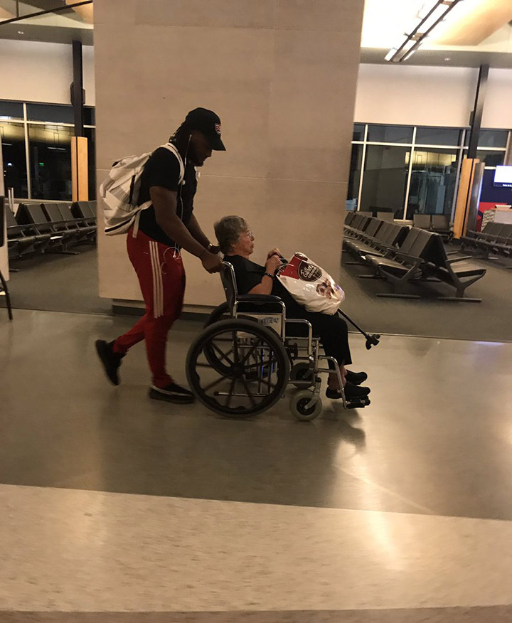 nfl player pushes woman in wheelchair at airport