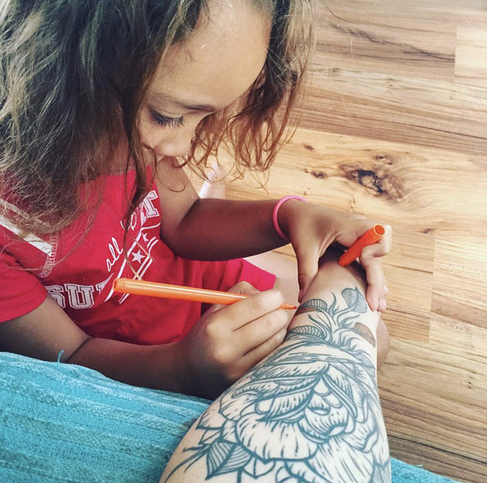 mom lets daughter color in her tattoos