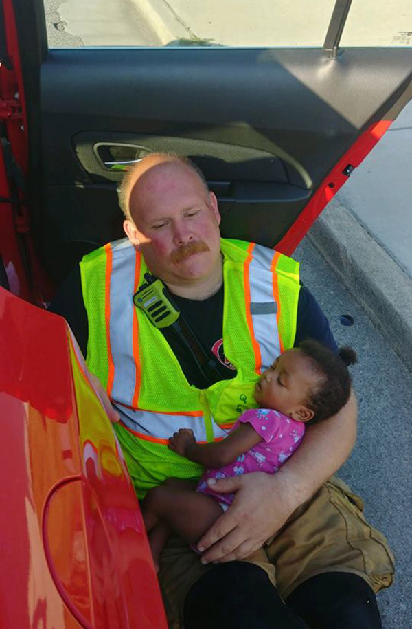 firefighter cradles baby after accident