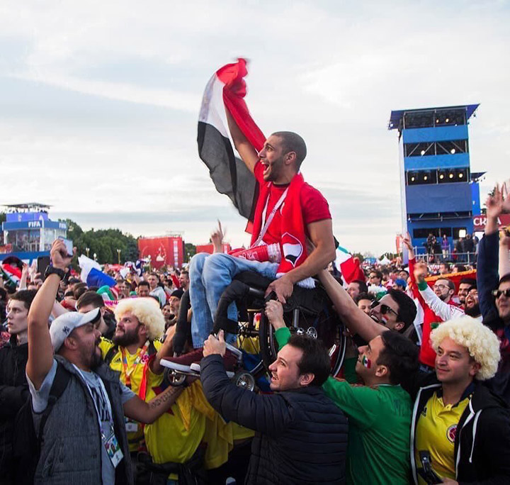 mexican and colombian fans hold up egyptian fan in wheelchair acts of kindness world cup